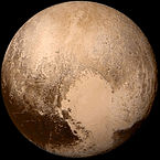 Image of Pluto with three main shades of brown that cover the surface